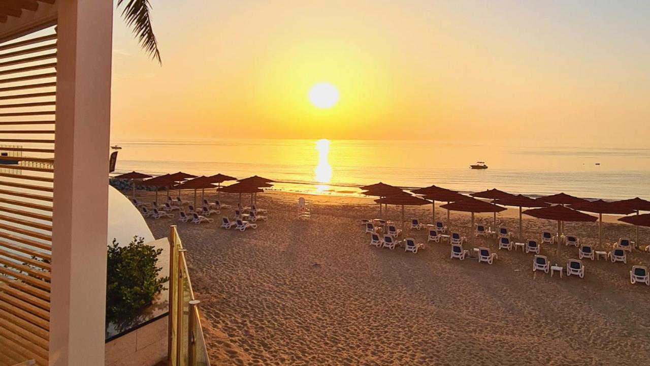 Royal M Al Aqah Beach Resort By Gewan Exterior photo Sunset at the beach